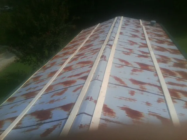 Rusted metal roof panels with new wood purlins before replacement — Storm Damage Roof Repair in American Falls by Roofing Brothers