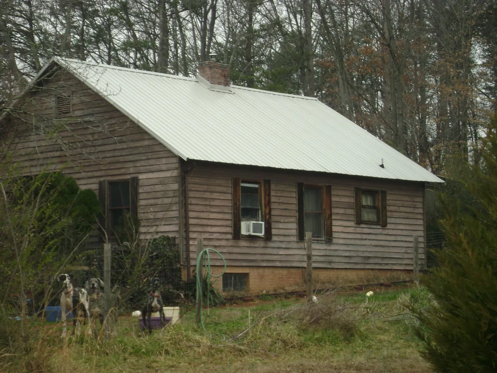 White metal roof on an old wood sided farmhouse, from a Metal Roof Installation job in American Falls